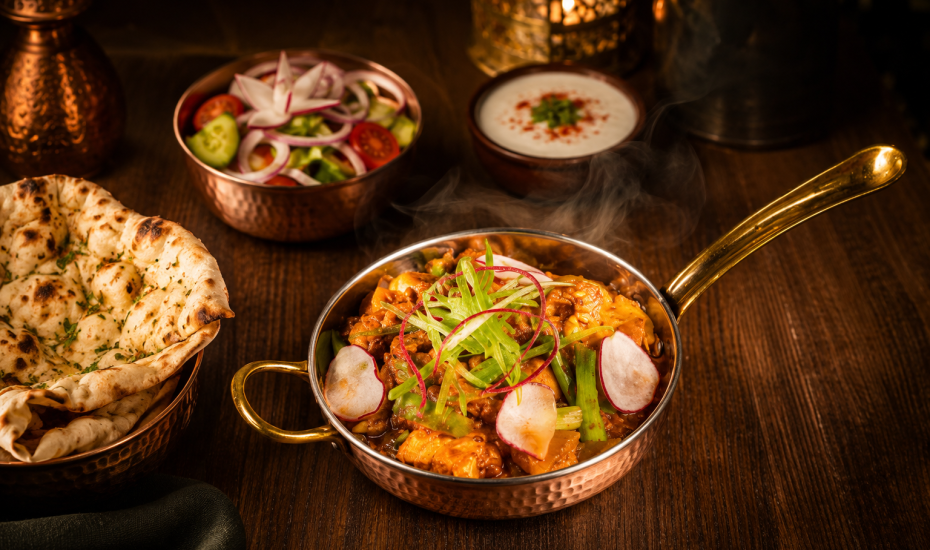 Chef's Special Mixed Veg featuring fresh seasonal vegetables sautéed in aromatic Indian spices, garnished with radish and scallions, served in a traditional copper bowl.