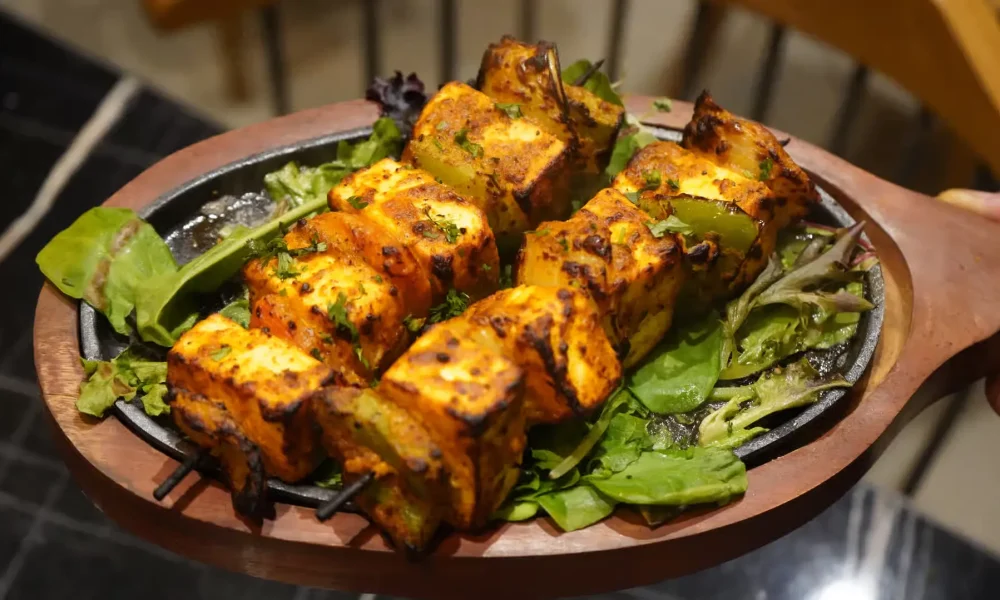 Indian paneer tikka made with marinated grilled cottage cheese and vegetables.