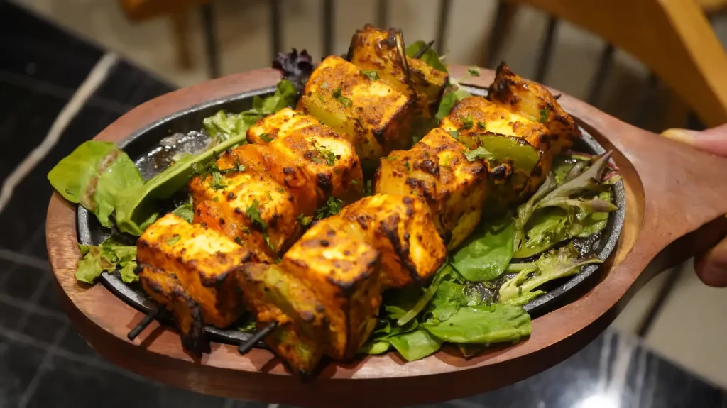 Indian paneer tikka made with marinated grilled cottage cheese and vegetables.
