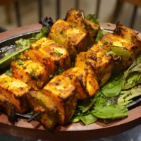 Indian paneer tikka made with marinated grilled cottage cheese and vegetables.