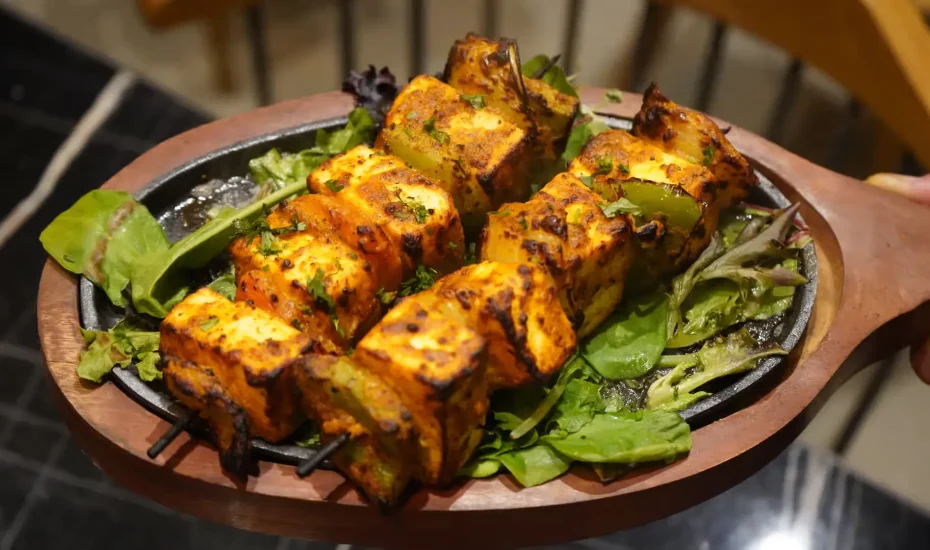Indian paneer tikka made with marinated grilled cottage cheese and vegetables.