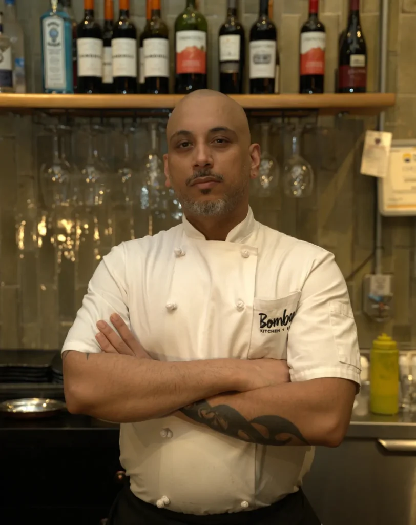 Chef Andy, head chef at Bombay Kitchen + Bar, standing in the restaurant kitchen.